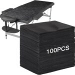 Stack of 100 black FELISTORY disposable non-woven massage table sheets, folded neatly.