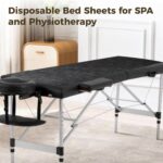 Stack of 100 black FELISTORY disposable non-woven massage table sheets, folded neatly.