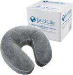 Stack of 50 clear, fitted disposable headrest covers for massage tables, neatly packed in a box.