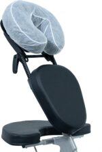 Stack of 50 clear, fitted disposable headrest covers for massage tables, neatly packed in a box.