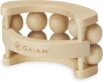 A wooden handheld massage ball roller with multiple independent rolling balls and a curved ergonomic handle.