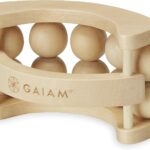 A wooden handheld massage ball roller with multiple independent rolling balls and a curved ergonomic handle.