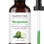 Amber glass bottle of Majestic Pure Bergamot Essential Oil with a built-in dropper, 1 fl oz size, on a white background.