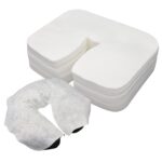 Stack of 200 white disposable face cradle covers made of soft cotton, designed for massage tables and spa chairs.