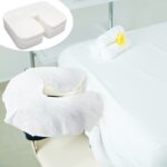 Stack of 200 white disposable face cradle covers made of soft cotton, designed for massage tables and spa chairs.