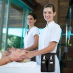Black SITHON professional massage therapist holster bag with an adjustable waist belt, shown with two bottle pockets.