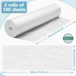 Two rolls of white disposable non-woven massage table sheets, neatly stacked and ready for use in a professional setting.