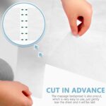 Two rolls of white disposable non-woven massage table sheets, neatly stacked and ready for use in a professional setting.