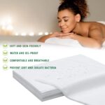 Stack of 100 white disposable bed sheets for massage and spa tables, neatly folded.