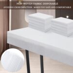 Stack of 100 white disposable bed sheets for massage and spa tables, neatly folded.